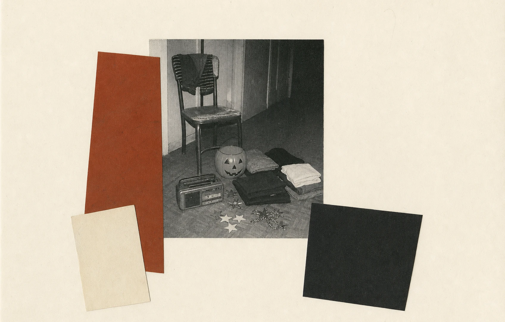 A grainy, flash-lit hallway still life of a pumpkin bucket, plain folded clothes in several sizes, a tiny pet sweater, and an unbranded cassette player.