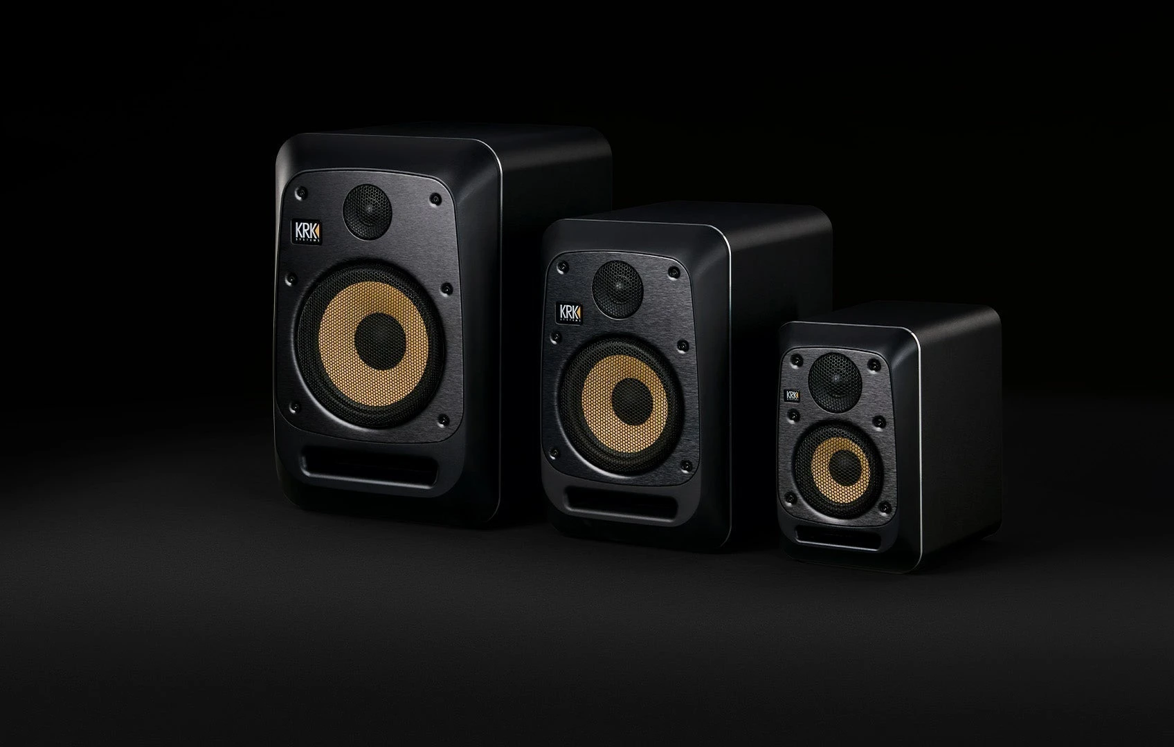 KRK V Series Five studio monitors in three sizes on a dark background